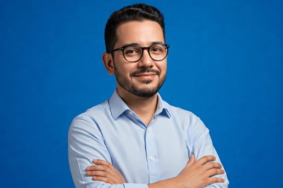 A digital marketing specialist looking casual but professional over a blue-colored background.